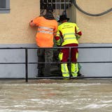 Hochwasser-Einsatz im Juli: Zivilschutz und Feuerwehr deponieren Sandsäcke vor dem Eingang eines Wohnhauses in Mellingen. (Alexandra Wey / KEYSTONE)