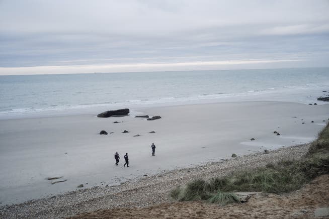 French police officers guard a beach in Wimereux, in northern France.