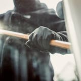 Burglary breaking into family home with a crowbar (Ppampicture / iStockphoto)