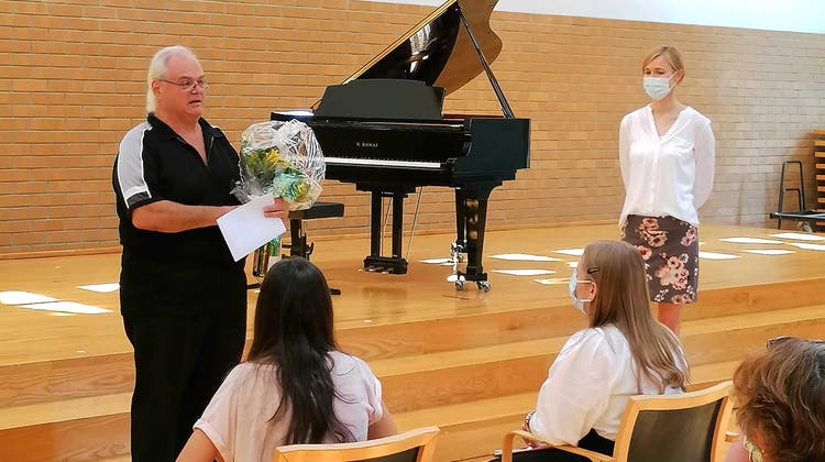 Blumen zum Abschied: Livio Castioni (links) zusammen mit Daniela Jordi-Körte und seinen Musikschülern. (Bild: Maurus Held)