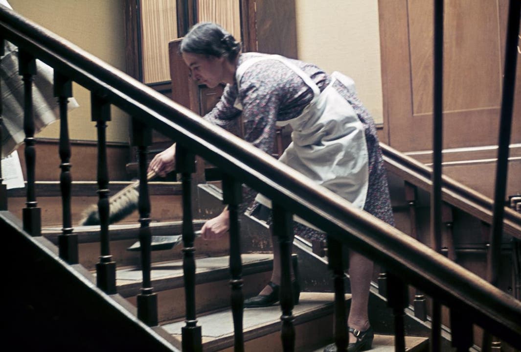 Zimmermädchen beim Wischen einer Treppe im Hotel Engel, Liestal 1941. Nach damaliger Einweisung in Haushaltkursen wurden Treppen immer von oben links nach rechts, stufenweise gewischt.