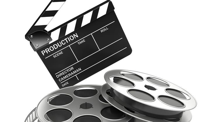 Cinema and video industry concept. Slate board and film reel. 3d rendered image (Umbertopantalone / iStockphoto)