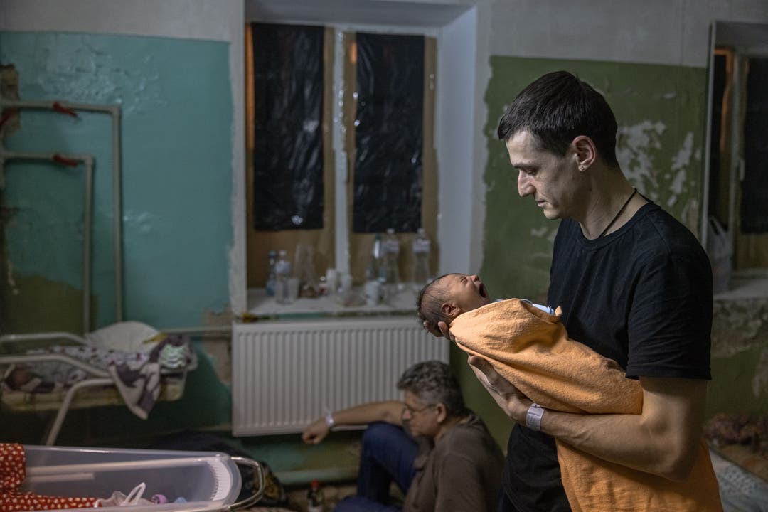 Ein Vater hält sein Neugeborenes in einem Spital in Kiew (2. März 2022)
