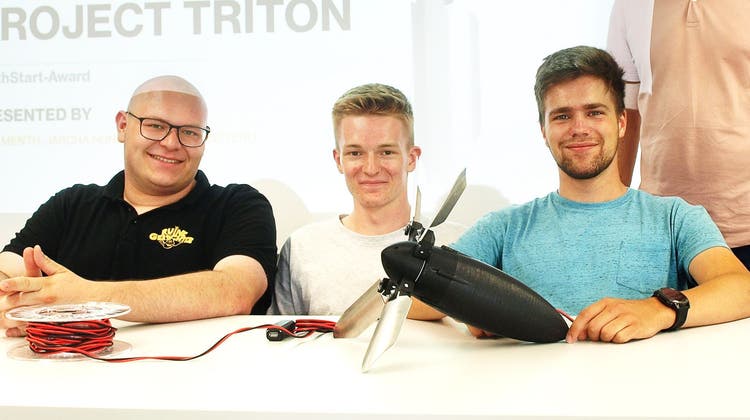 Projektteam Triton: Von links Jascha Hunziker, Gian Menth, Severin Bitterli und Berufsschullehrer Thomas Büttiker haben Triton vor sich liegen. (Urs Huber)