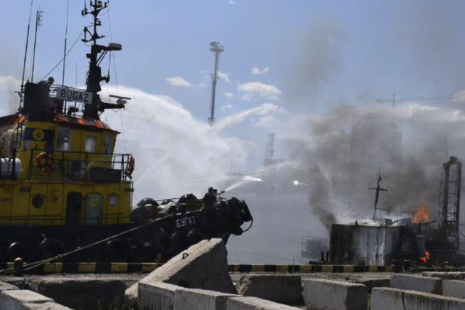 Ukrainian firefighters are fighting a fire after Russian missiles hit the port of Odessa.