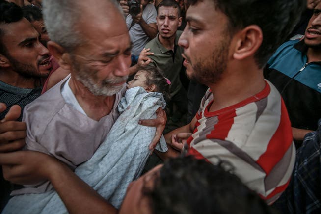 Five-year-old Alaa Qadoum's grandfather cries at her funeral after she was killed in the Israeli attack.