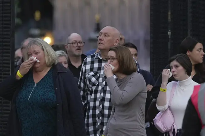 People weep as they leave Queen Elizabeth II's state funeral in London September 14, 2022.