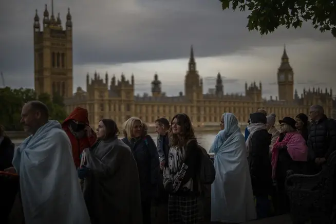 People queue to pay their respects to the late Queen Elizabeth II during the funeral ceremony outside Westminster Hall in London, September 18, 2022.