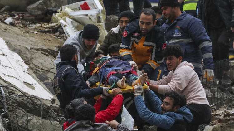 Helfer transportieren einen verletzten Mann ab: Unter den zerstörten Gebäuden in der türkischen Stadt Adana werden viele weitere Verschüttete vermutet. (Elifaysenurbay / AP)