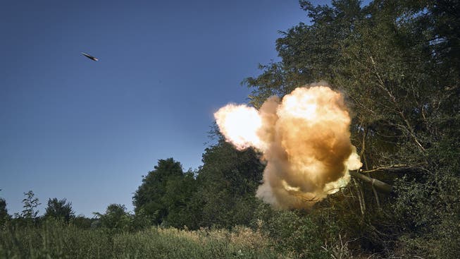 Ukrainian soldiers fire howitzers at Russian positions in the Donetsk region.